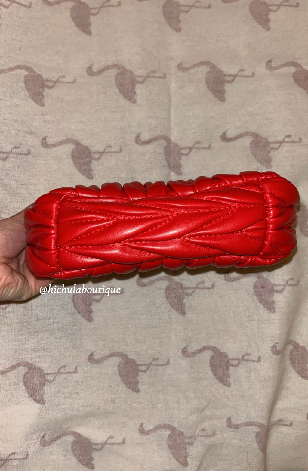 Red quilted leather bag with gold hardware