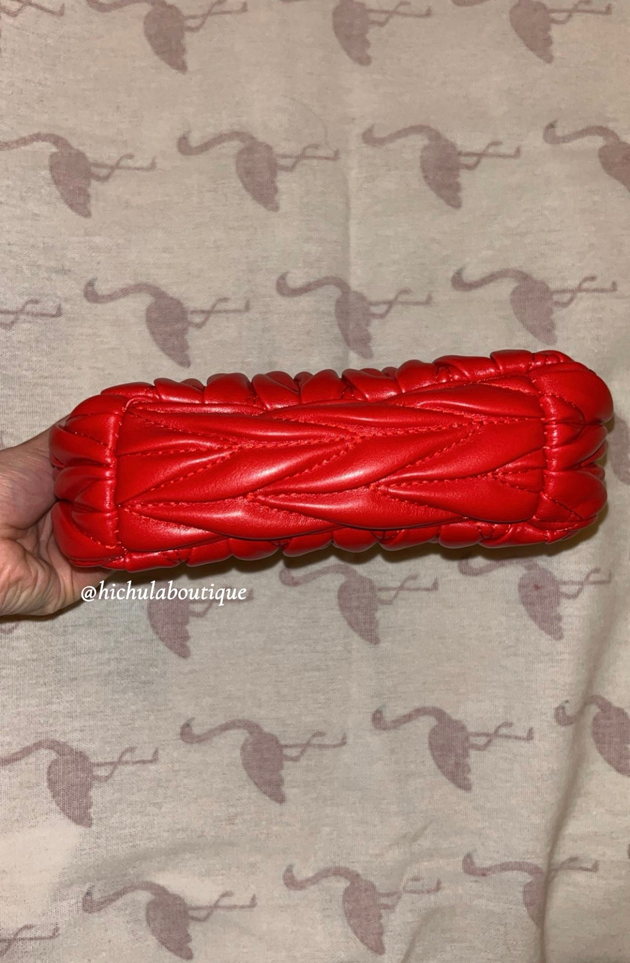 Red quilted leather bag with gold hardware