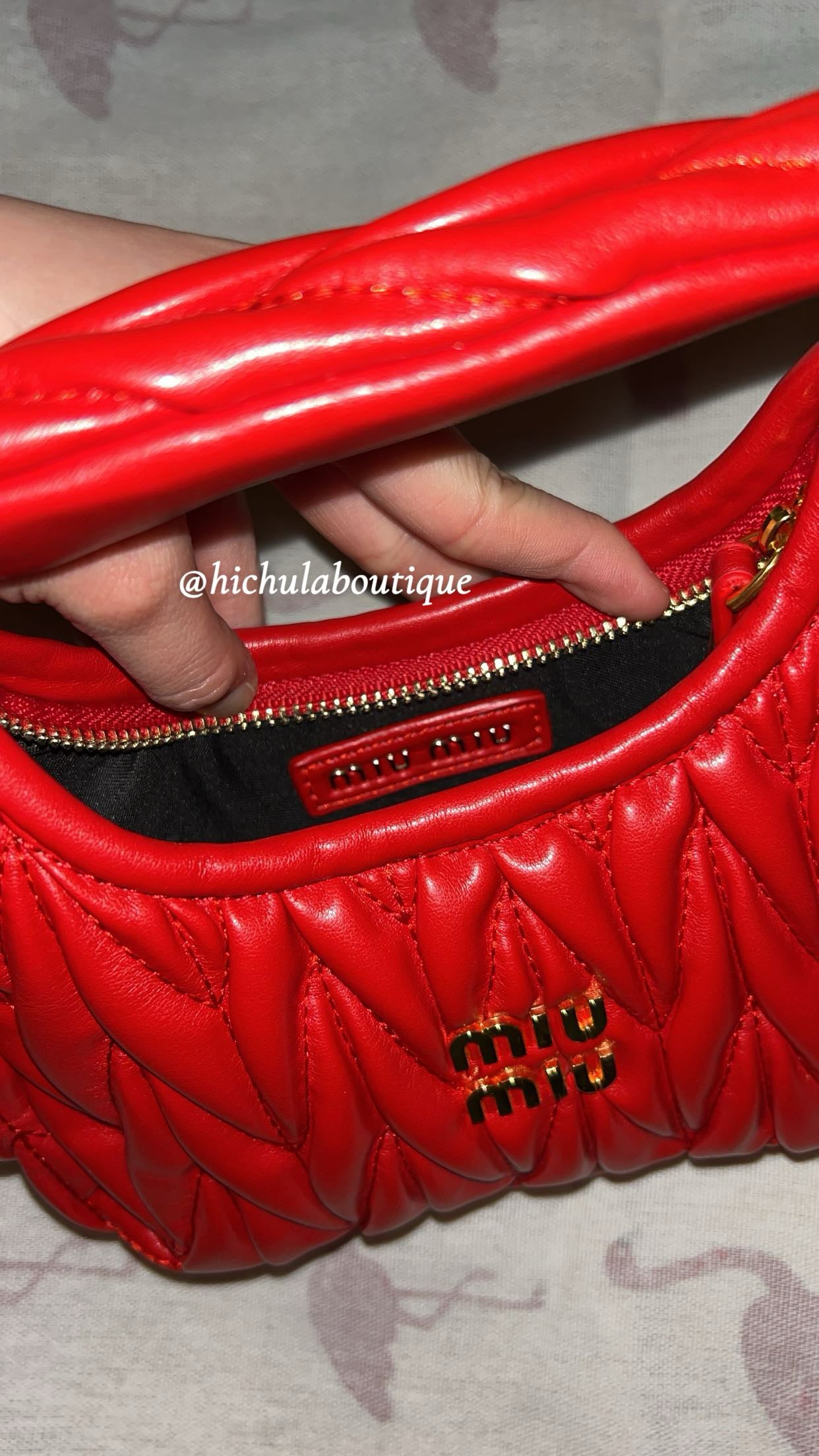 Red quilted leather bag with gold hardware