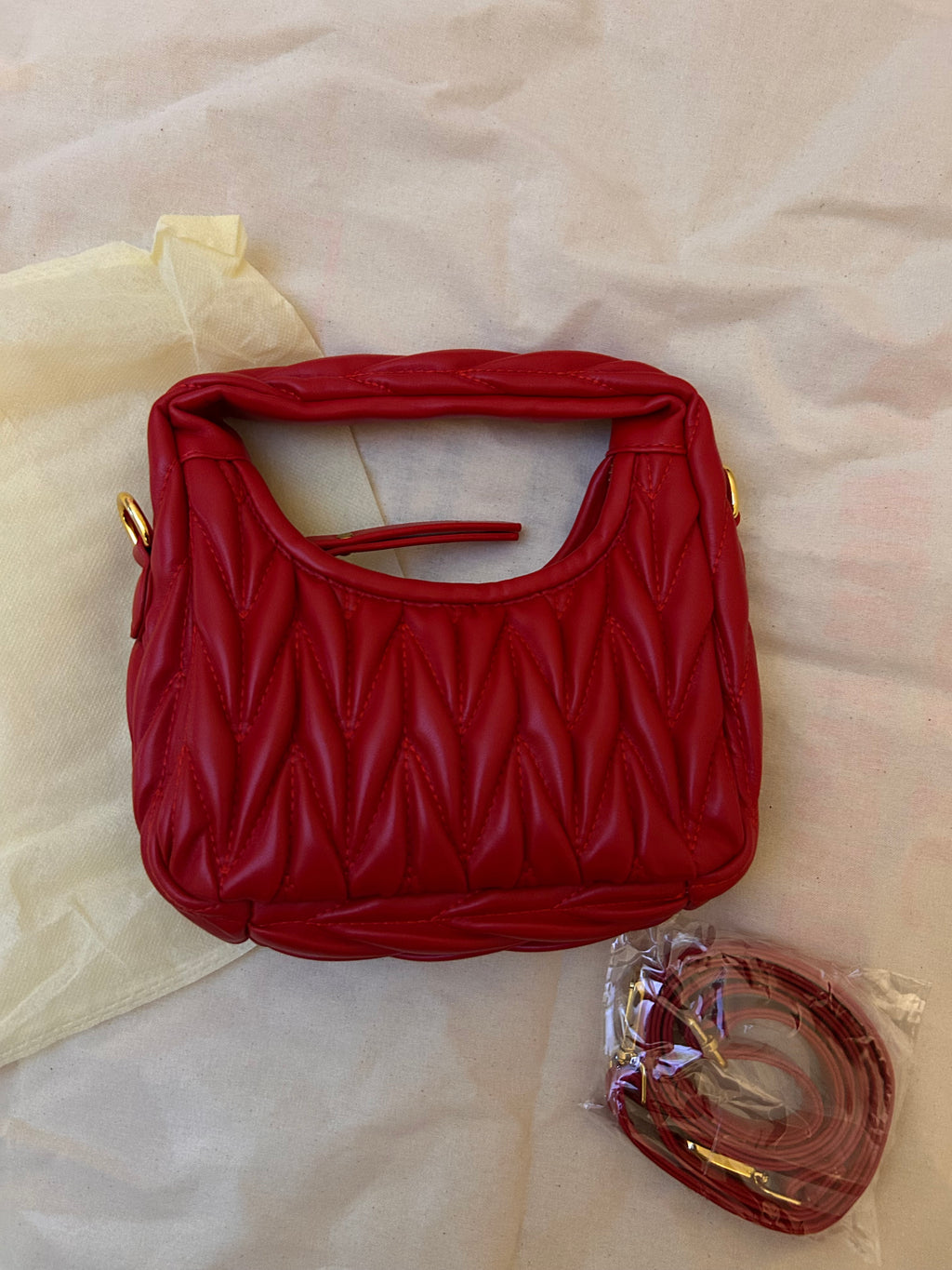 Red quilted leather bag with gold hardware