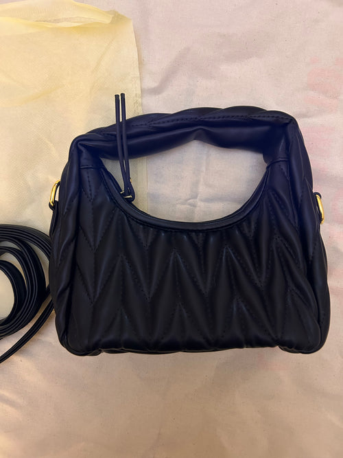 Black quilted leather bag with gold hardware