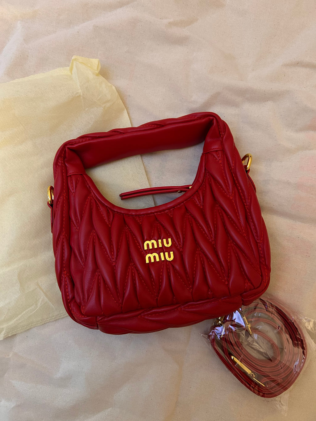 Red quilted leather bag with gold hardware