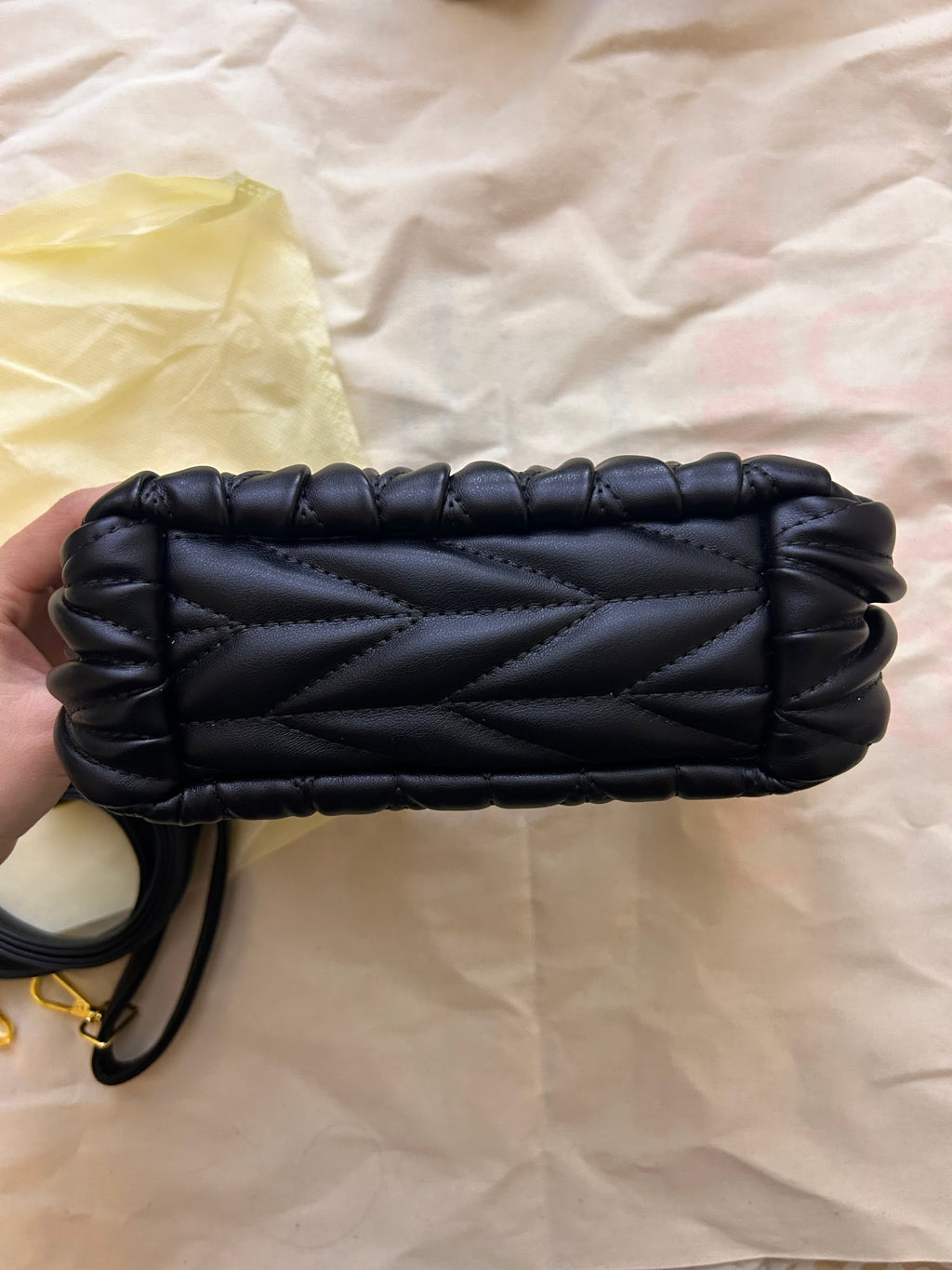 Black quilted leather bag with gold hardware