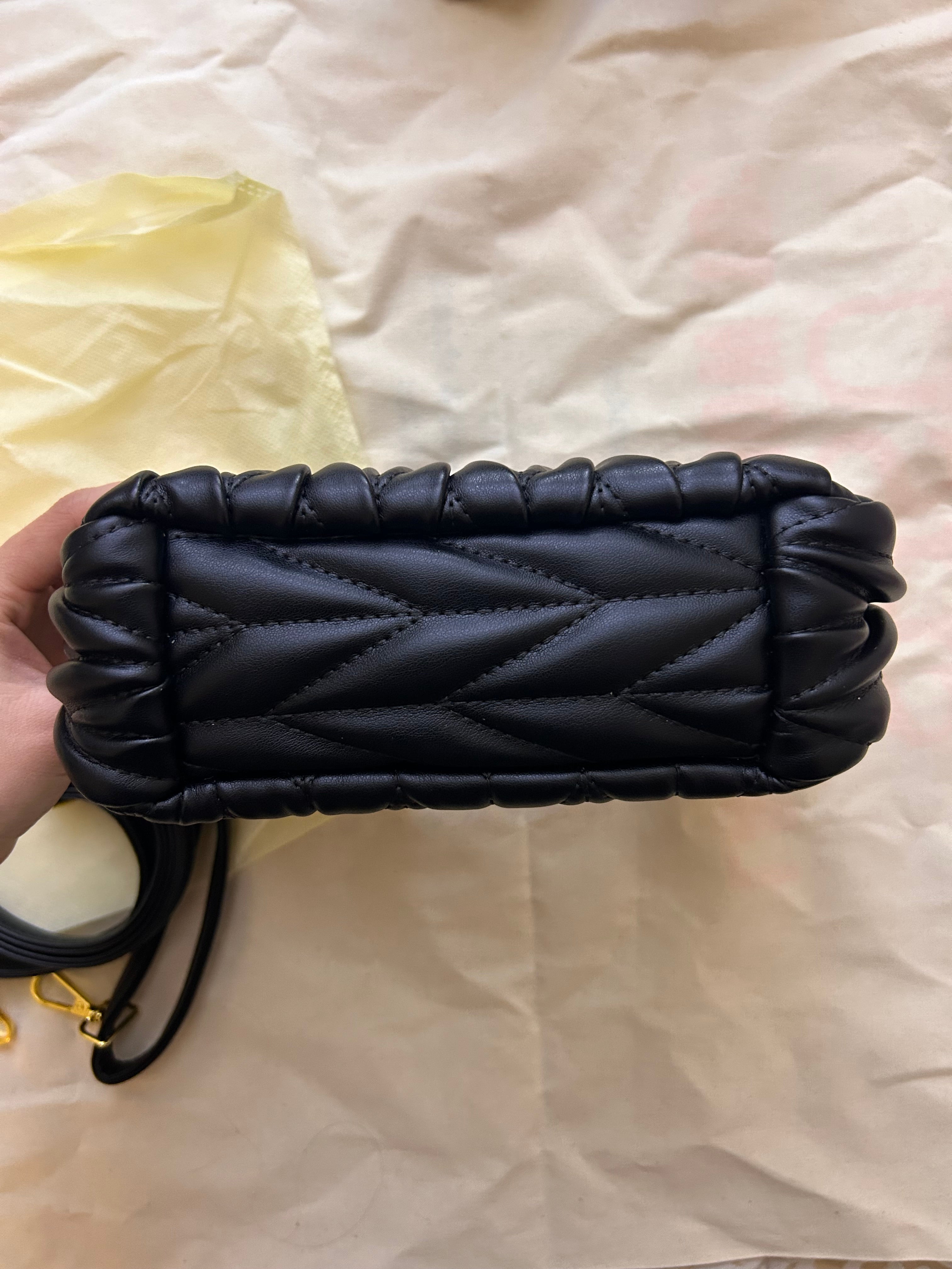 Black quilted leather bag with gold hardware
