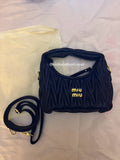 Black quilted leather bag with gold hardware