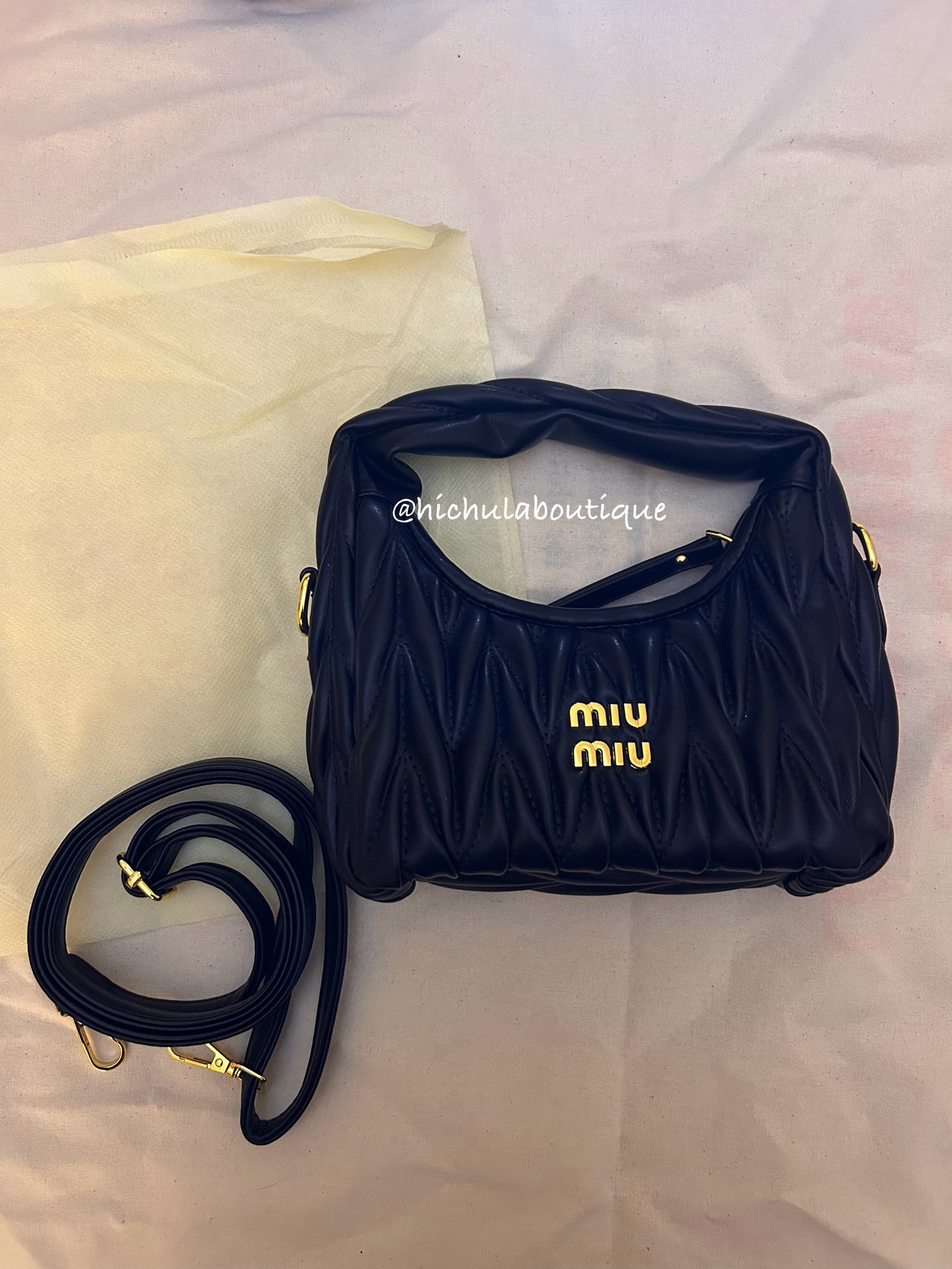 Black quilted leather bag with gold hardware